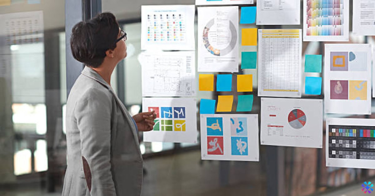Business leader analyzing data charts and strategy boards, showing how time in Bentonville shapes decision-making and leadership at Walmart suppliers.